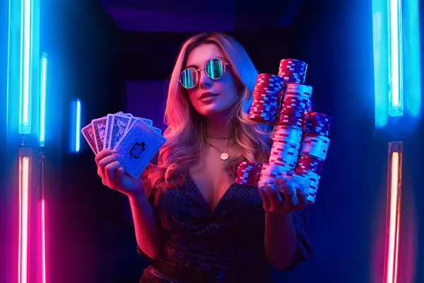 A glamorous woman holding casino chips in a neon-lit environment, representing the premium online casino atmosphere of SPINARA.