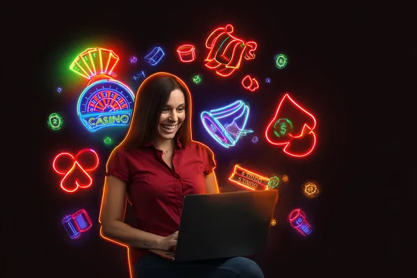 A woman smiling while playing online games on her laptop, surrounded by neon casino elements, showcasing SPINARA’s diverse game collection.